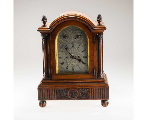 A LATE VICTORIAN OAK STRIKING TABLE CLOCK, CIRCA 1890 the arched case with acorn finials, side sound frets, silvered dial ela