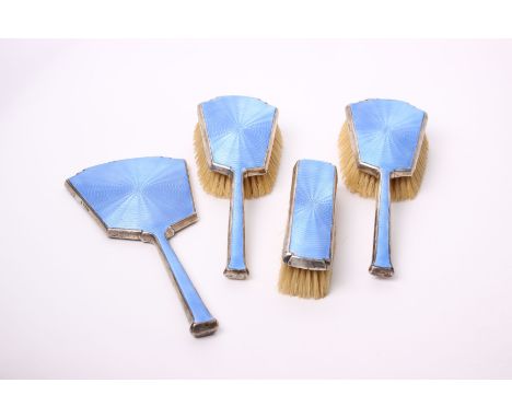 A silver and pale blue enamel brush set, Birmingham 1930, W. Neale &amp; Son Ltd, comprising three brushes and one hand mirro