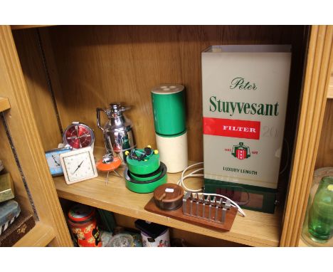 A Peter Stuyvesant cigarette advertising lamp (sold as parts), with four vintage clocks and vintage kitchenware.    