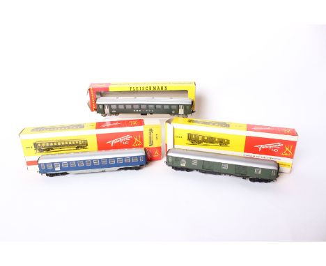 Three Fleischmann HO wagons, a  1504 B DB Pack Trolley in green together with a 1509B Touropa passenger carriage and a Swiss 