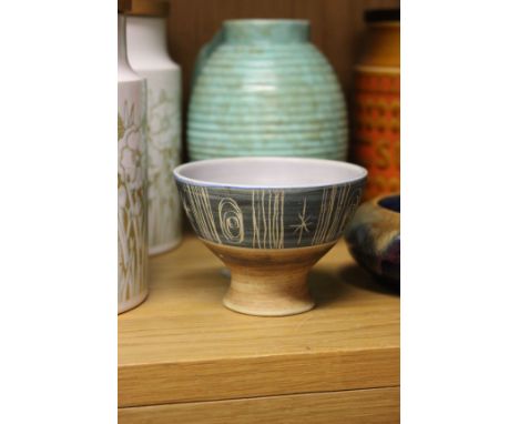 A flared ceramic footed bowl in the style of Lucie Rie, decorated with mauve, blue and brown glaze and scraffito marks, with 