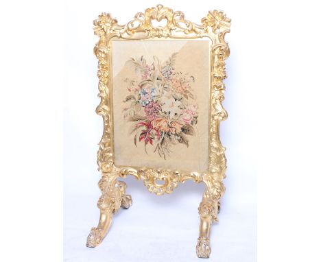 A 19th Century giltwood firescreen with an inset floral needlework panel, 112cm high (a.f.)