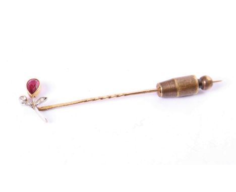 An unmarked yellow and white metal stick pin, set with pear cut ruby and rose and old cut diamonds, in fitted box, 2.6g.