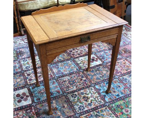 An 'Arts &amp; Crafts' oak table with pull-out top and a frieze drawer.