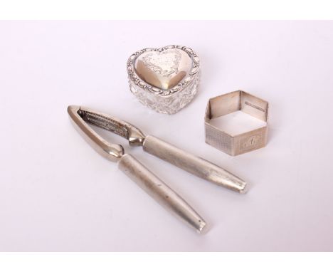 A pair of sterling silver handled nut crackers by Mappin &amp; Webb; together with a heart shaped silver topped cut glass box