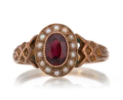 GARNET AND SEED PEARL RING set with central ruby within a halo of seed pearls, marked 9CT, size OQty: 2.1g