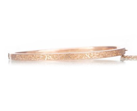 NINE CARAT ROSE GOLD BANGLE  with bright cut foliate decoration, initialled 'E. J. R.' in italics to interior, Birmingham 189