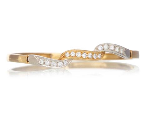 DIAMOND BANGLE  with round brilliant cut diamonds to the central panel. in eighteen carat gold  Qty: 14.5g  Generally worn, s