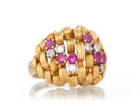 RUBY AND DIAMND RING  set with small rubies and diamonds amongst reeded curved panels, in eighteen carat gold, size L 1/2  Qt