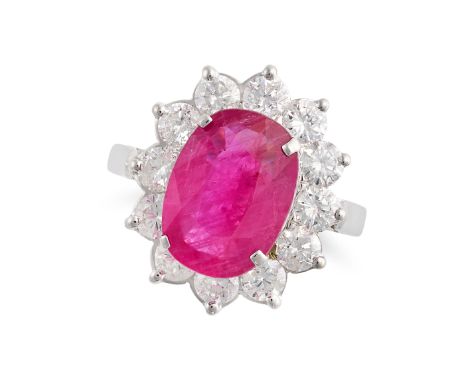 A RUBY AND DIAMOND CLUSTER RING in 18ct white gold, set with an oval cut ruby of 3.71 carats in a cluster of round brilliant 