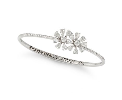 A DIAMOND FLOWER BANGLE in 18ct white gold, the hinged body comprising two flower motifs set with a round brilliant cut diamo
