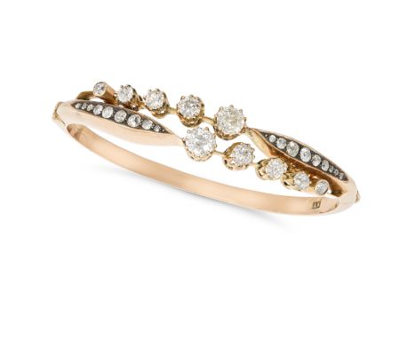 AN ANTIQUE RUSSIAN DIAMOND BANGLE in 56 zolotnik gold, the hinged bangle set with rows of old cut diamonds, the diamonds all 