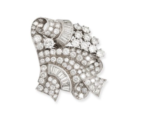 A VINTAGE DIAMOND BROOCH / PENDANT in scrolling design set throughout with round brilliant and tapered baguette cut diamonds,