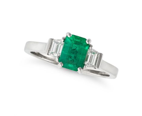 AN EMERALD AND DIAMOND THREE STONE RING in platinum, set with an octagonal step cut emerald of 1.00 carats accented on each s