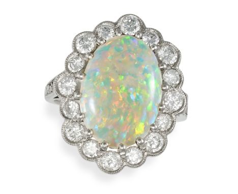 AN OPAL AND DIAMOND CLUSTER RING set with a cabochon opal in a cluster of round brilliant cut diamonds, the band set with fur