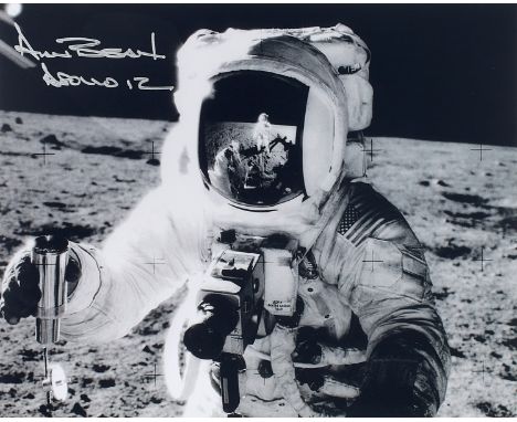NO RESERVE Space.- Apollo 12.- Conrad (Pete) Alan Bean holds a lunar soil sampler, the photographer reflected in his visor, s