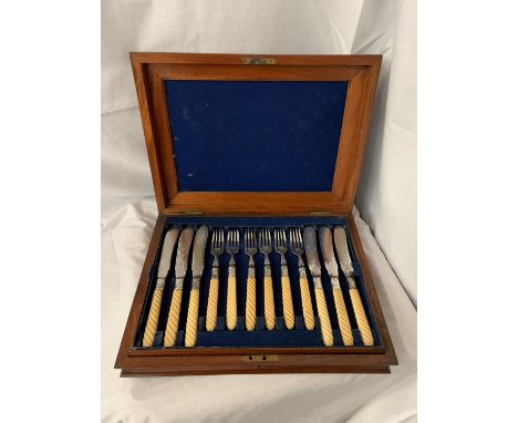 A VINTAGE MAHOGANY CANTEEN OF FLATWARE HEALY ENGRAVED WITH BARLEY TWIST HANDLES. SIX PLACE SETTING OF DINNER FORKS AND KNIVES