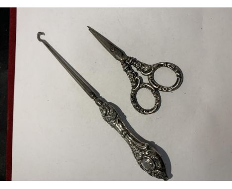 A SILVER HANDLED BUTTON HOOK AND A PAIR OF SILVER HANDLED SISSORS 