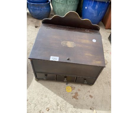 A VINTAGE STORAGE BOX WITH UPPER LIFTING LID AND THREE SMALL DRAWERS 