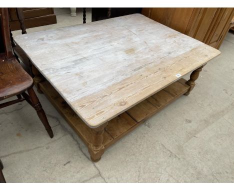 A RUSTIC PINE COFFEE TABLE WITH LOWER SHELF 