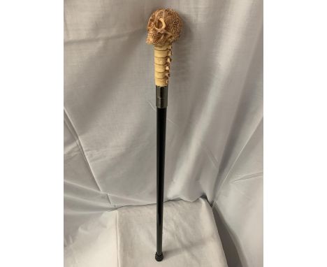 A SKULL HANDLE WALKING STICK 