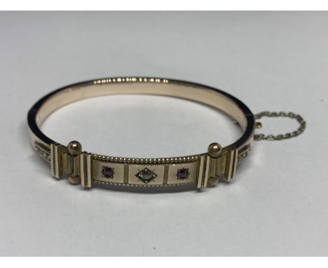 A DIAMOND AND RUBY BANGLE TESTED 9 CARAT GOLD GROSS WEIGHT 11.1 GRAMS 