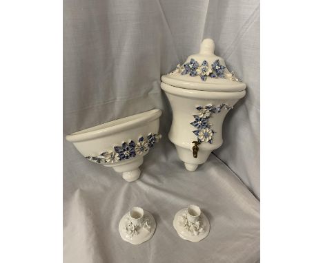 A PAIR OF CERAMIC WALL MOUNTED WATER VESSEL AND BOWLWITH DECORATIVE BLUE AND WHITE FLOWERS IN RELIEF, ONE WITH A SMALL TAP AN