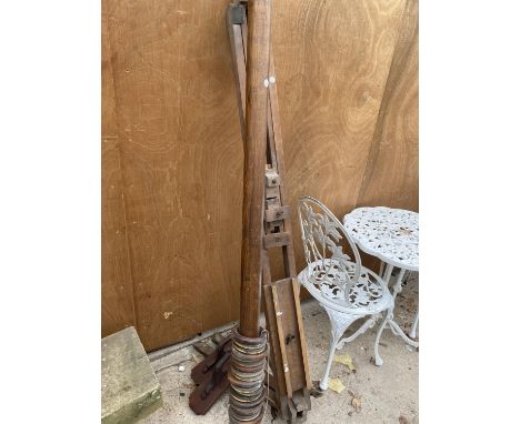 A VINTAGE WOODEN ARTISTS EASEL AND A FURTHER WOODEN CURTAIN POLE 