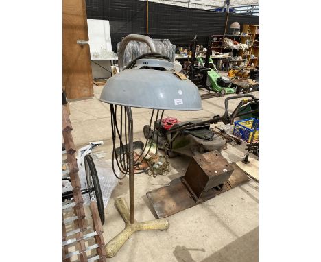 AN INDUSTRIAL STYLE LAMP ON A HEAVY CAST IRON BASE 