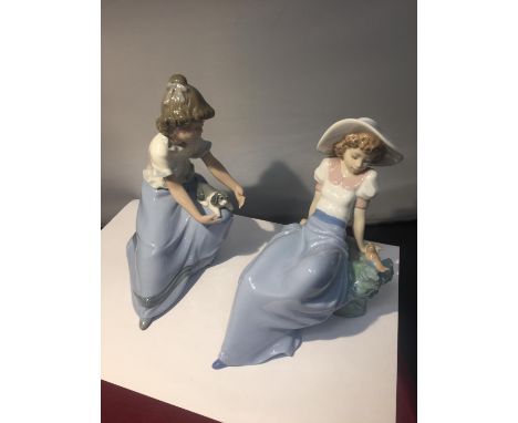 TWO NAO FIGURES OF GIRLS ONE WITH A PUPPY AND ONE WITH A BIRD 