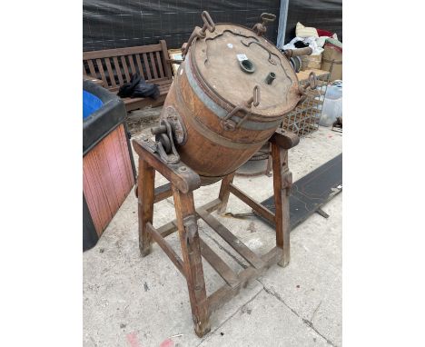 A VINTAGE WOODEN BUTTER CHURN ON A STAND 