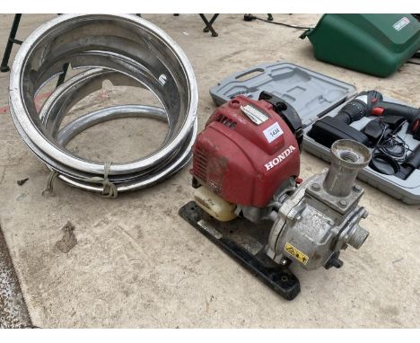 A HONDA ENGINE AND A COLLECTION OF RIMS 
