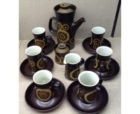 A 1970'S DENBY ARABESQUE PATTERN COFFEE SERVICE Comprising a coffee pot, a sugar and cream and six cups and saucers. 