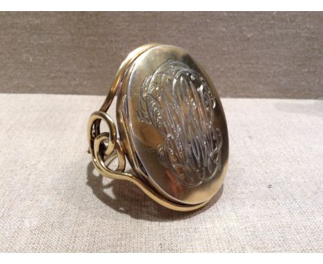 A 19TH CENTURY WHITE METAL AND GILT BANGLE With hinged compartments and bearing engraved initials. (approx 5½cm x 7cm)