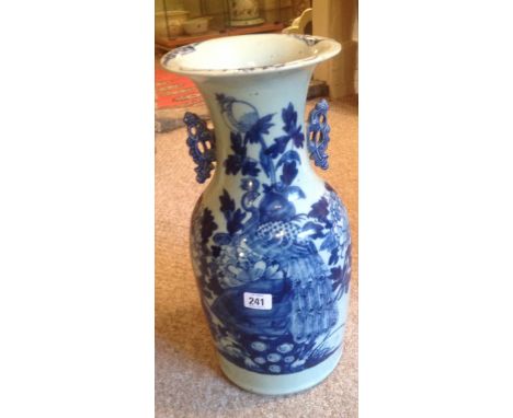 A 19TH CENTURY CHINESE BLUE AND WHITE VASE Decorated with a foliage handle, bearing a brown wax seal to underside 'Customs Pe