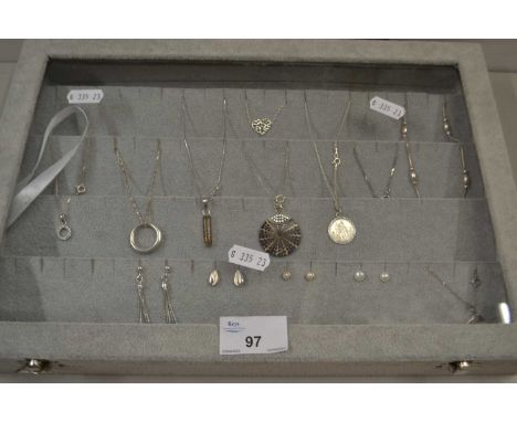 Display case containing various silver and white metal necklaces, earrings etc