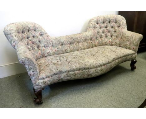 A Victorian settee, circa 1860, with shaped button down upholstered curved back and serpentine fronted stuff over seat in tap