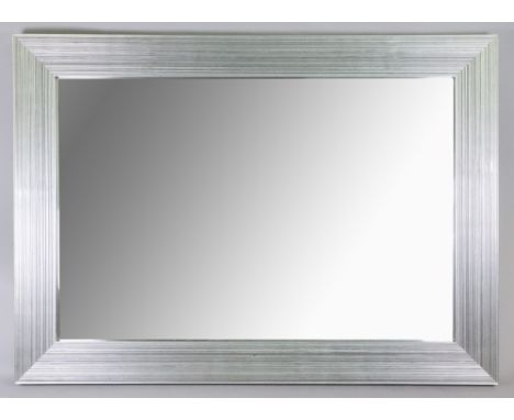 A contemporary 'ribbed silver' moulded rectangular wall mirror, 91 x 66cm, another in moulded pine frame, 102 x 71cm and a Jo