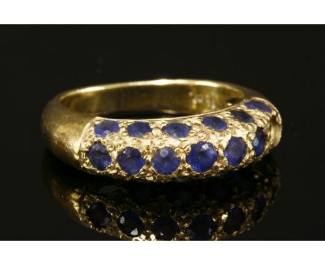 A gold pavé set sapphire bombe ring,marked 18ct, several stones deficient, 7.91g.Finger size K½