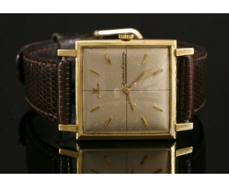 A gentlemen's 18ct gold Jaeger LeCoultre mechanical strap watch,with a square case 27mm diameter.  Silvered dial with raised 