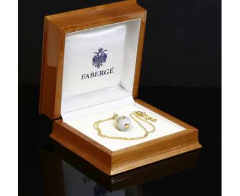 An 18ct gold contemporary enamelled egg pendant and chain,by Victor Mayer for Fabergé.  The translucent, duck-egg blue, guill