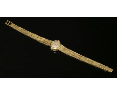 A ladies' 18ct gold Cyma mechanical 'Cymaflex' bracelet watch,with circular silvered dial, raised gilt batons and hands.  Int