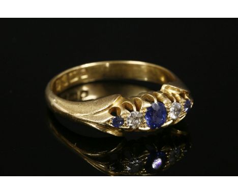 An 18ct gold Edwardian sapphire and diamond boat-shaped ring,with five graduated mixed cut sapphires and old Swiss cut diamon