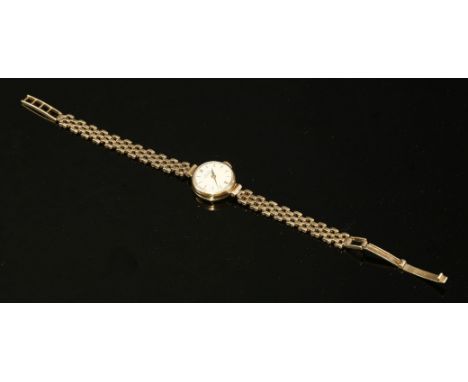 A ladies' 9ct gold Girard-Perregaux mechanical watch,on a later 9ct gold bracelet.  A circular case and silvered dial with gi