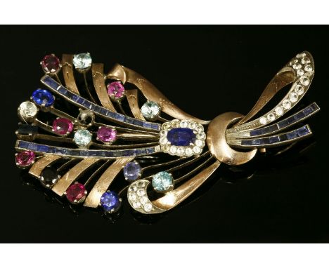 A gold and silver gemstone spray brooch,with rubies, sapphires, blue and white zircons, one deficient, claw set to gold engra