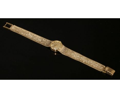 A ladies' 9ct gold Omega mechanical bracelet watch, c.1970,with a circular champagne dial with raised gilt and black batons a