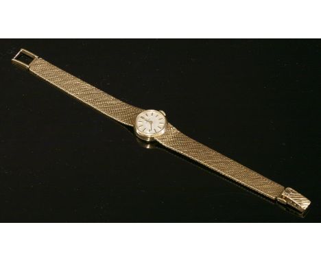 A ladies' 9ct gold Omega mechanical bracelet watch,with a circular case, silvered dial, raised gilt batons and hands.  An int
