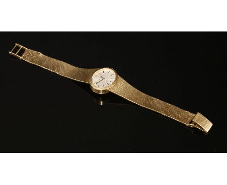 A ladies' 9ct gold 'Miss Tudor Genève' mechanical bracelet watch, c.1975,with an oval silvered landscape dial with gilt raise