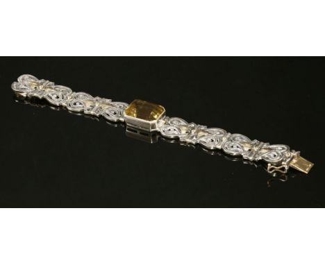 A cased Arts & Crafts sterling silver and gold citrine bracelet, c.1960,by Sibyl Dunlop.  An emerald cut citrine, milligrain 