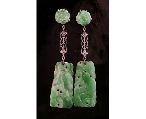 A pair of Art Deco jade and diamond drop earrings, with a carved jade flower head, claw set to the top.  A pierced milligrain